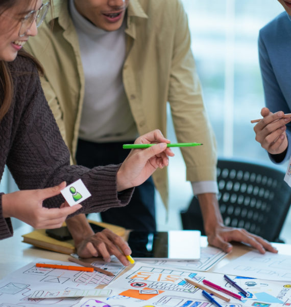 creative digital development agency brainstorming about mobile app interface wireframe design on desk at modern office.